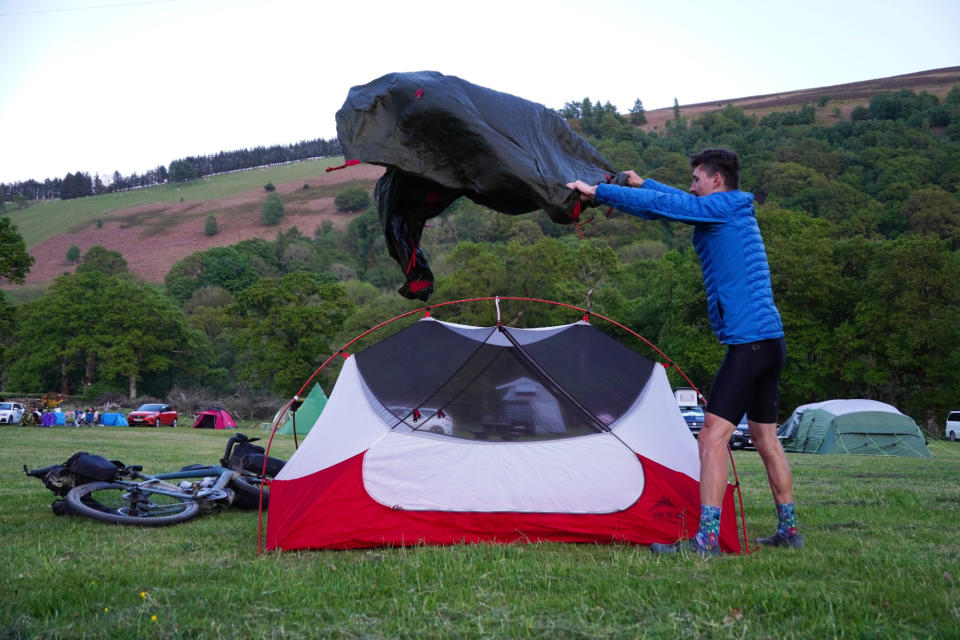 Stefan Abram putting up a tent at the Elan Oaks campsite along the Trans Cambrian Way.