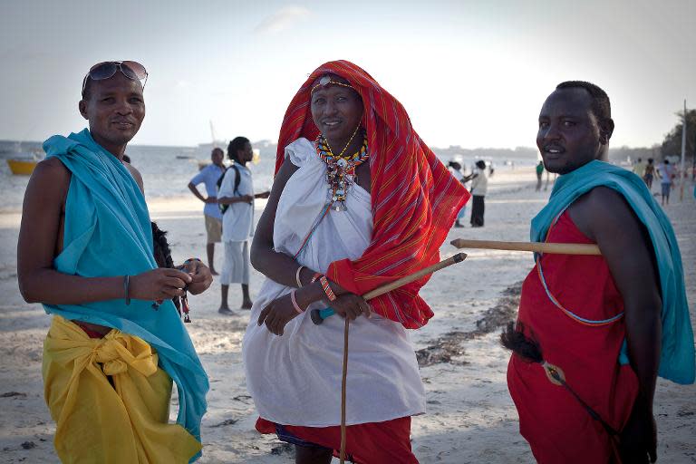 Samburu men wait to sell traditional crafts to tourists on Bamburi beach in the coastal city of Mombasa on February 22, 2014