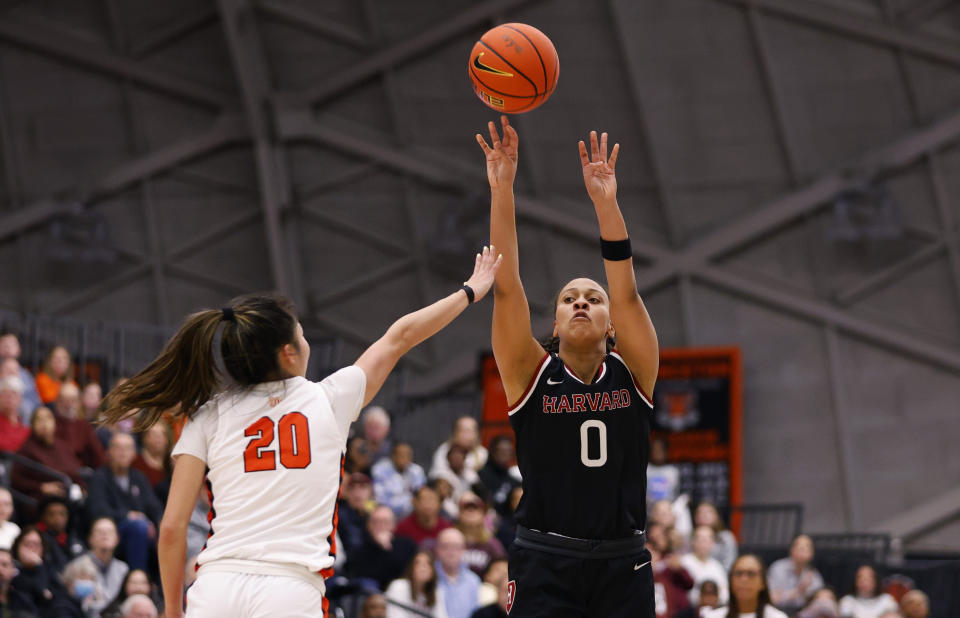 Harvard guard McKenzie Forbes (0) shoots as Princeton guard Kaitlyn Chen (20) defends during the first half of the Ivy League championship NCAA college basketball game, Saturday, March 11, 2023, in Princeton, N.J. (AP Photo/Noah K. Murray)