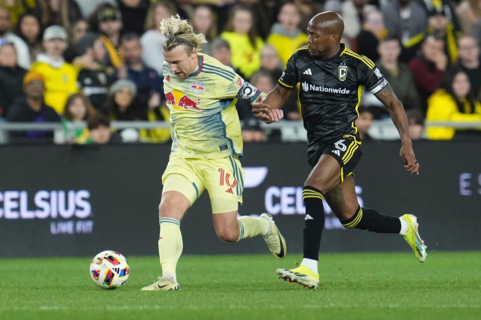 Mar 16, 2024; Columbus, Ohio, USA; New York Red Bulls midfielder Emil Forsberg (10) dribbles past Columbus Crew midfielder Darlington Nagbe (6) during the second half of the MLS soccer match at Lower.com Field. Mandatory Credit: Adam Cairns-USA TODAY Sports