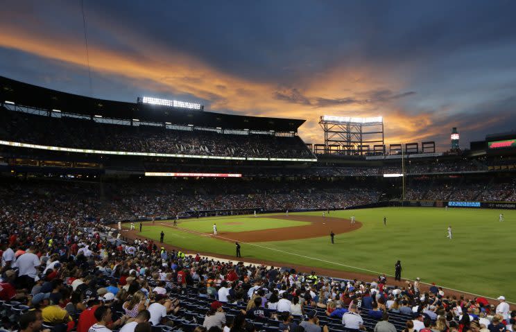 The sun sets behind Turner Field during a baseball game between Philadelphia Phillies and Atlanta Braves Saturday, July 30, 2016, in Atlanta. (AP Photo/John Bazemore)