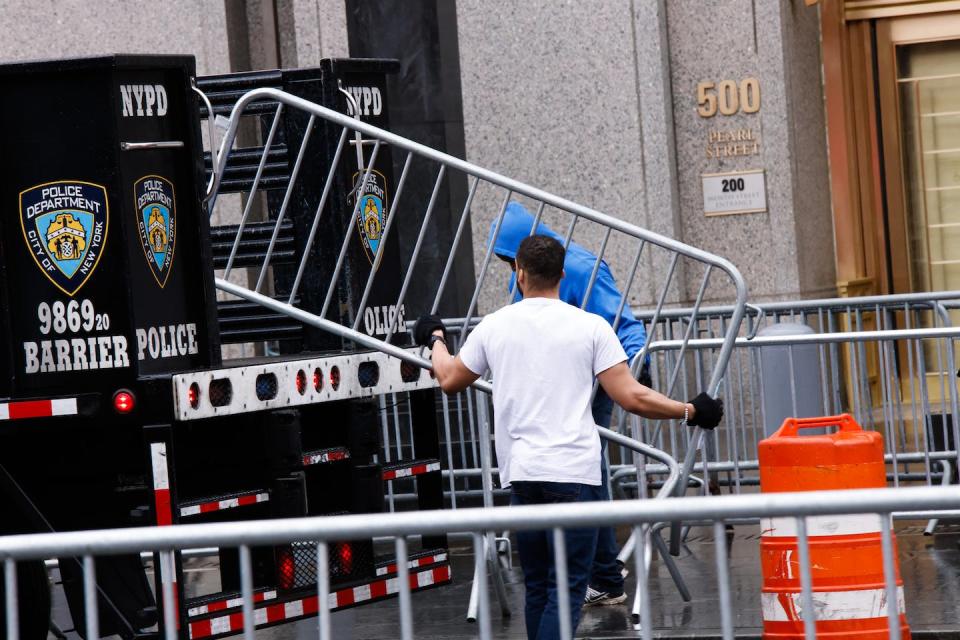 New York Police Department workers set up barricades outside the offices of the Manhattan district attorney on April 1, 2023, in New York City. <a href="https://www.gettyimages.com/detail/news-photo/workers-with-the-nypd-set-up-barricades-outside-the-offices-news-photo/1250351591?adppopup=true" rel="nofollow noopener" target="_blank" data-ylk="slk:Kena Betancur/Getty Images;elm:context_link;itc:0;sec:content-canvas" class="link ">Kena Betancur/Getty Images</a>