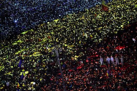 Protesters display the Romanian national flag colours during a demonstration in front of the government building in Bucharest, Romania, February 12, 2017. Inquam Photos/Liviu Florin Albei via REUTERS