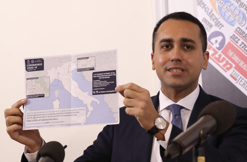 Italian Foreign Minister Luigi di Maio holds up a map of Italy showing the municipalities in regions of Lombardy and Veneto where it is not possible to travel, during a press conference at the foreign press association, in Rome, Thursday, Feb. 27, 2020. The government is seeking to calm fears about the outbreak, which has seen countries issue travel advisories warning their citizens to avoid visiting hard-hit Lombardy and Veneto regions, which have seen the most cases. (AP Photo/Alessandra Tarantino)