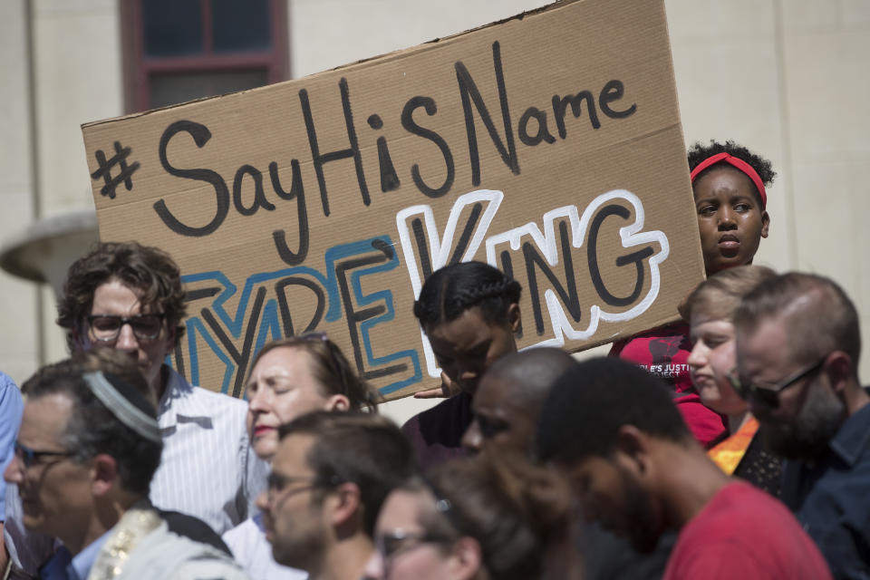 FILE - Demonstrator Ciara Humphrey, right, holds a sign during a rally for Tyre King, a 13-year-old Ohio boy who was fatally shot by Columbus police, on Sept. 19, 2016, outside City Hall in Columbus, Ohio. A federal jury on Wednesday, Jan. 25, 2023, has found that a white Ohio police officer did not violate King's civil rights when he shot and killed the boy while responding to a reported armed robbery. (AP Photo/John Minchillo, File)