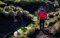 Chris Dean, Head of Moors for the Future Partnership walks through an area of damaged Peat moorland on Black Ashop moor near Glossop