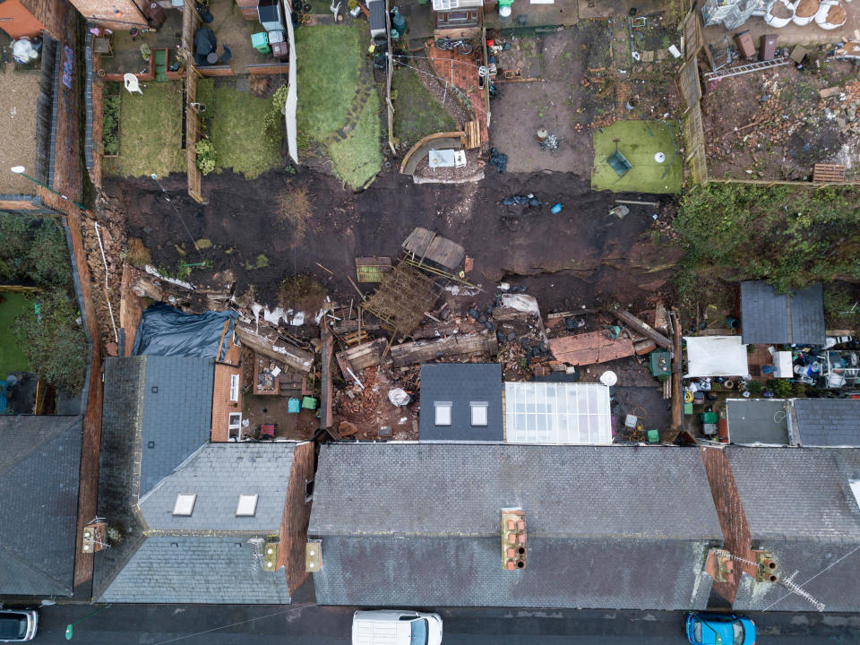 A 70 foot wall has fallen into the gardens of properties in Nottingham after heavy rainfall, February 04, 2021.  Five families were evacuated from their homes in the middle of the night after reports of a 'landslide' in Nottingham.  See SWNS story SWMDwall.  Distressed residents were woken up by the noise of a tonne of bricks, rubble and earth falling into their back gardens of their terraced houses after a 70-foot high wall collapsed.  Nottinghamshire police said five families from four houses had to be evacuated in the pouring rain in Sneinton at 1am on February 3.  Officers arrived at the scene to discover severe damage to their homes, with bathrooms and kitchens flooded.