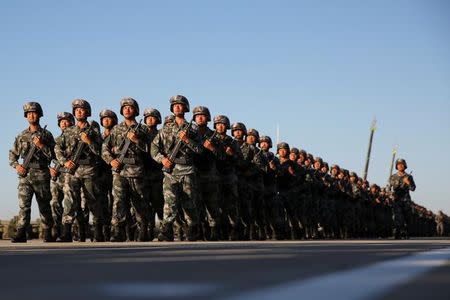 Soldiers arrive for a military parade to commemorate the 90th anniversary of the foundation of China's People's Liberation Army (PLA) at the Zhurihe military training base in Inner Mongolia Autonomous Region, China, July 30, 2017. REUTERS/Stringer/Files