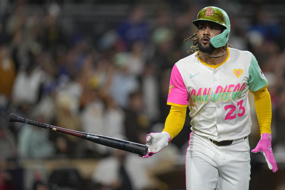 San Diego Padres' Fernando Tatis Jr. tosses hit bat after hitting a home run during the third inning of a baseball game against the Toronto Blue Jays, Friday, April 19, 2024, in San Diego. (AP Photo/Gregory Bull)