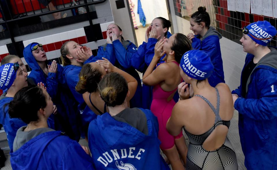 Dundee swimmers get fired up before the start of swimming in the Monroe County Swim Finals Saturday.