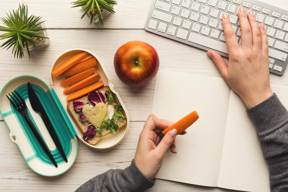 Try not to eat within reach of your desk while working remotely. It's important to take mental breaks and unplug. (Photo: Prostock-Studio via Getty Images)