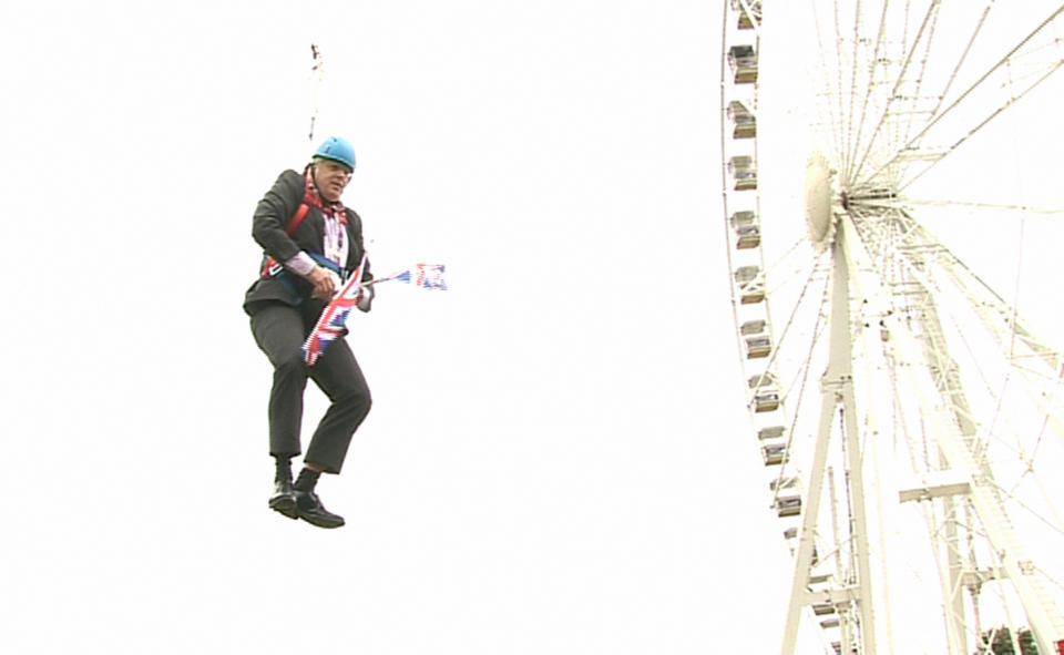 London Mayor Boris Johnson as he is left hanging in mid-air after he got stuck on a zipwire at an Olympic event at Victoria Park in the capital.   (Photo by Ben Kendall/PA Images via Getty Images)