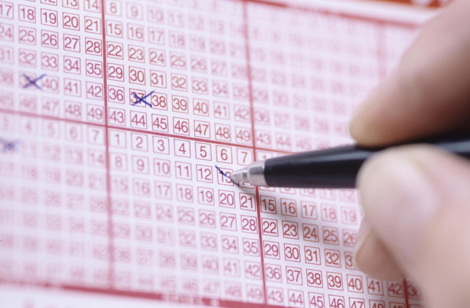 A woman has been told she needs to forfeit her $1000 lottery win. Pictured is a person filling out numbers on a lotto form.