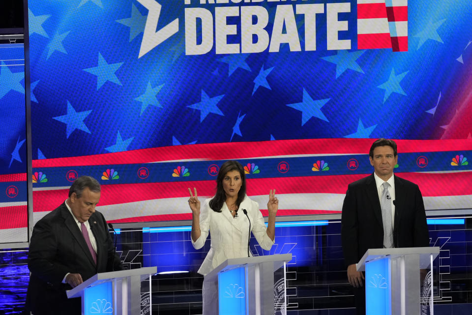 Republican presidential candidate former U.N. Ambassador Nikki Haley speaks as former New Jersey Gov. Chris Christie ad Florida Gov. Ron DeSantis listen during a Republican presidential primary debate hosted by NBC News, Wednesday, Nov. 8, 2023, at the Adrienne Arsht Center for the Performing Arts of Miami-Dade County in Miami. (AP Photo/Rebecca Blackwell)