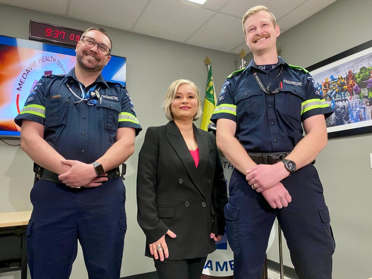 Saskatoon paramedics Matt McGurk (left) and Mitch Sparrow (right) meet Nicole Craig for the first time since they saved her life when she went into cardiac arrest in the downtown in April 2024. (Travis Reddaway/CBC - image credit)