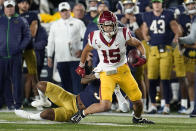 Southern California wide receiver Drake London (15) breaks the tackle of Notre Dame safety Houston Griffith (3) in the first half of an NCAA college football game in South Bend, Ind., Saturday, Oct. 23, 2021. (AP Photo/Paul Sancya)