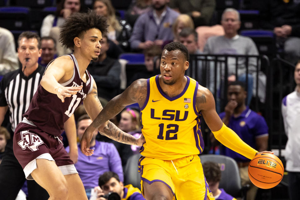 Feb 11, 2023; Baton Rouge, Louisiana; LSU Tigers forward KJ Williams (12) dribbles the ball against Texas A&M Aggies forward Andersson Garcia (11) during the second half at Pete Maravich Assembly Center. Stephen Lew-USA TODAY 