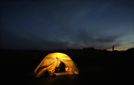 Reuters journalist Mari Saito works in her tent during the Cloud Appreciation Society's gathering on Lundy Island