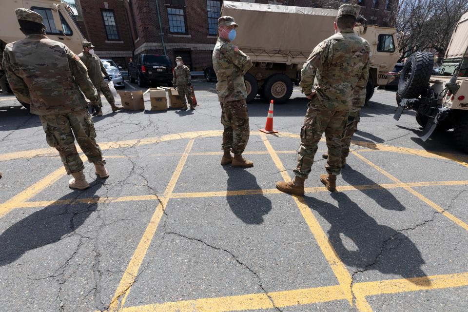 Massachusetts National Guard soldiers help with logistics in this Friday, April 17, 2020 file photo, at a food distribution site outside City Hall, in Chelsea, Mass. Mass. Gov. Charlie Baker on Monday, Sept. 13, 2021, activated the state's National Guard to help with busing students to school as districts across the country struggle to hire enough drivers.