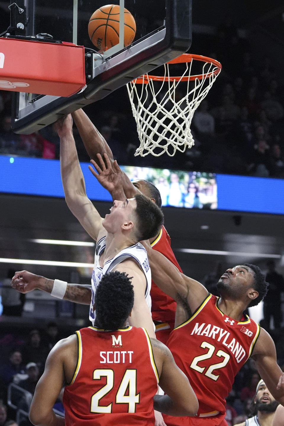 Northwestern guard Brooks Barnhizer shoots against Maryland forward Julian Reese, rear, and forward Jordan Geronimo (22) during the second half of an NCAA college basketball game in Evanston, Ill., Wednesday, Jan. 17, 2024. (AP Photo/Nam Y. Huh)