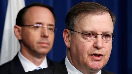 FILE PHOTO - U.S. Deputy Attorney General Rod Rosenstein (L) listens as acting DEA Administrator Chuck Rosenberg (R) speaks during a news conference on the dangers law enforcement and first responders face when encountering fentanyl at DEA Headquarters in Arlington, Virginia, U.S., June 6, 2017. REUTERS/Kevin Lamarque