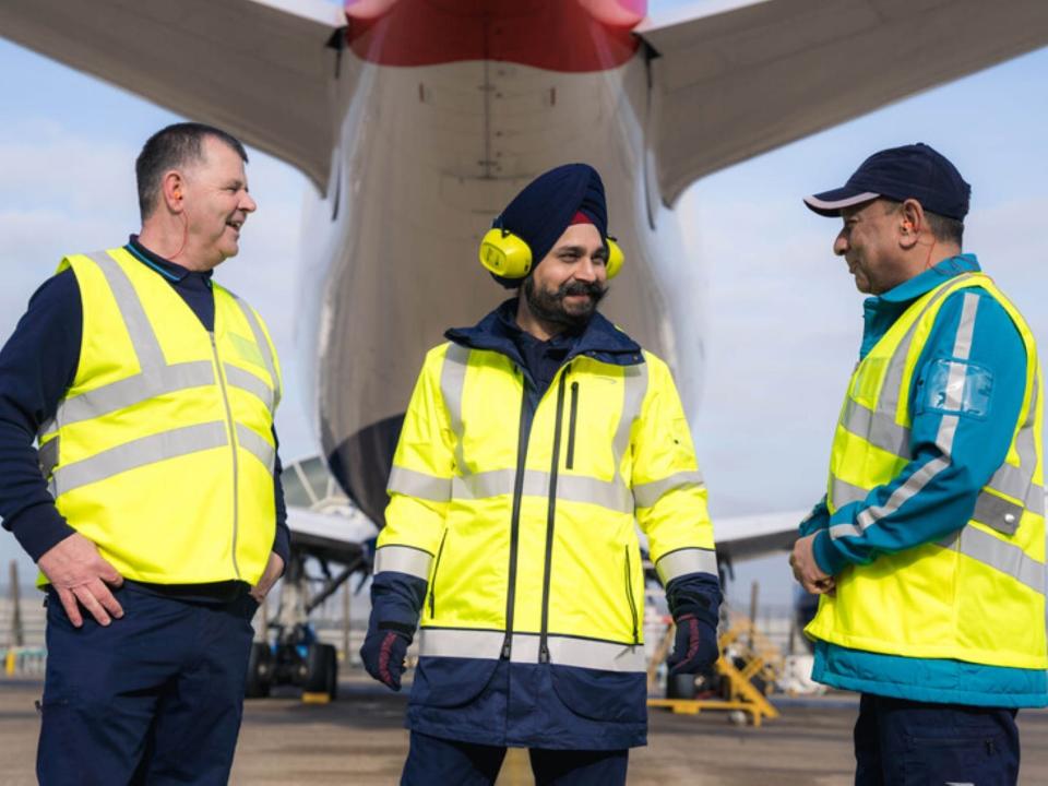 British Airways' new uniforms, yellow reflective jacket over blue top and pants.