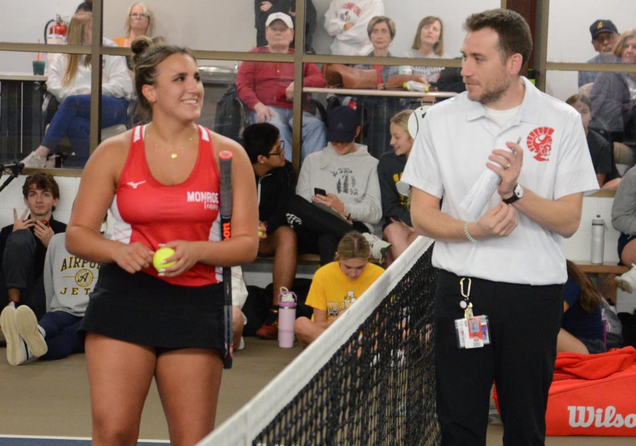 Monroe girls tennis coach Stephen Reau talks with No. 1 singles player Marisa Rostash during a break between sets Thursday.