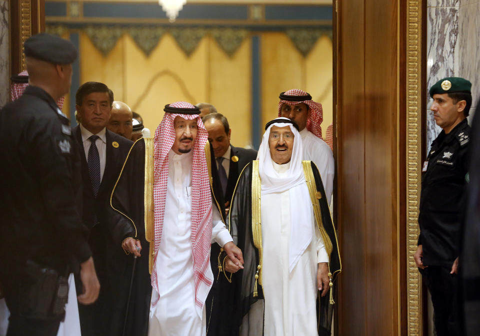 Saudi King Salman, center left, is accompanied by Kuwait's Emir Sheikh Sabah al-Ahmad al-Jaber al-Sabah, center right, as they enter the Islamic Summit of the Organization of Islamic Cooperation (OIC) in Mecca, Saudi Arabia, early Saturday, June 1, 2019. Muslim leaders from some 57 nations gathered in Islam's holiest city of Mecca late Friday to discuss a breadth of critical issues ranging from a spike in tensions in the Persian Gulf, to Palestinian statehood, the plight of Rohingya refugees and the growing threat of Islamophobia. (AP Photo/Amr Nabil)