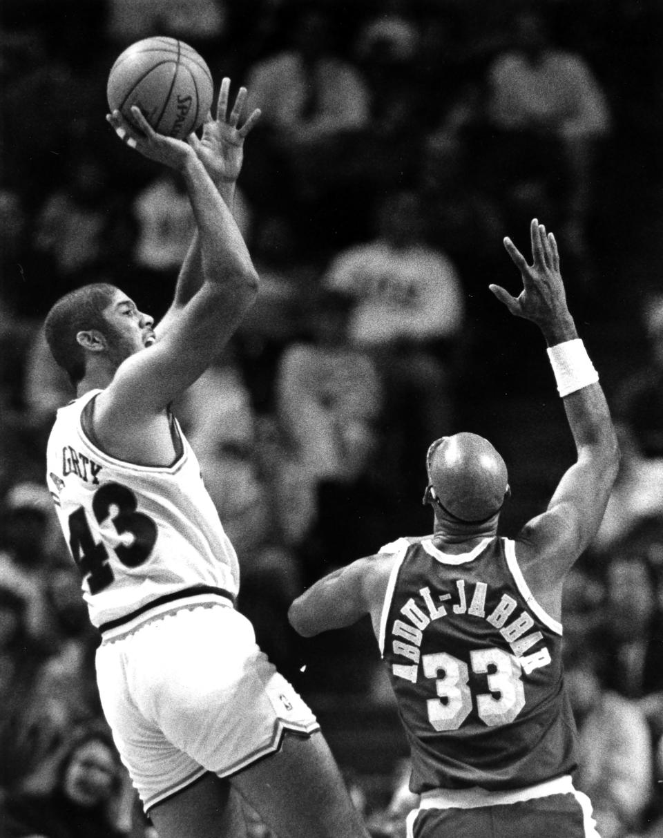 The Cleveland Cavaliers' Brad Daugherty, left, shoots over the Los Angeles Lakers' Karrem Abdul-Jabbar at the Richfield Coliseum, Dec. 13, 1988, in Richfield, Ohio.