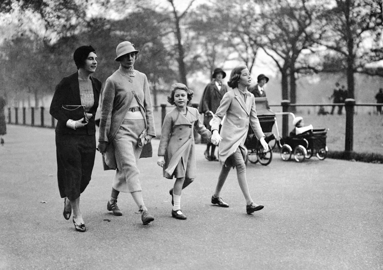 Britain's Princess Elizabeth, centrer, walking with a friend in Hyde Park, London, on Oct. 26, 1934.