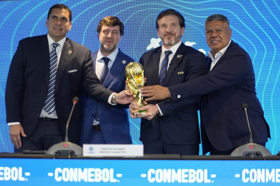 Paraguay’s Soccer Association President Robert Harrison, left, FIFA delegate Ignacio Alonso, center, Conmebol President Alejandro Dominguez, third from left, and Conmebol Vice President Claudio Tapia hold the World Cup soccer tournament trophy in Luque, Paraguay, Wednesday, Oct. 4, 2023. The press conference was to announce that some of the World Cup 2030 soccer tournament matches will be played in Argentina, Uruguay and Paraguay | Jorge Saenz, Associated Press