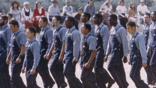 <p>Bruce Levine/Courtesy of Paramount+</p> Men marching in practice for the upcoming Renaissance wedding in Born in Synanon