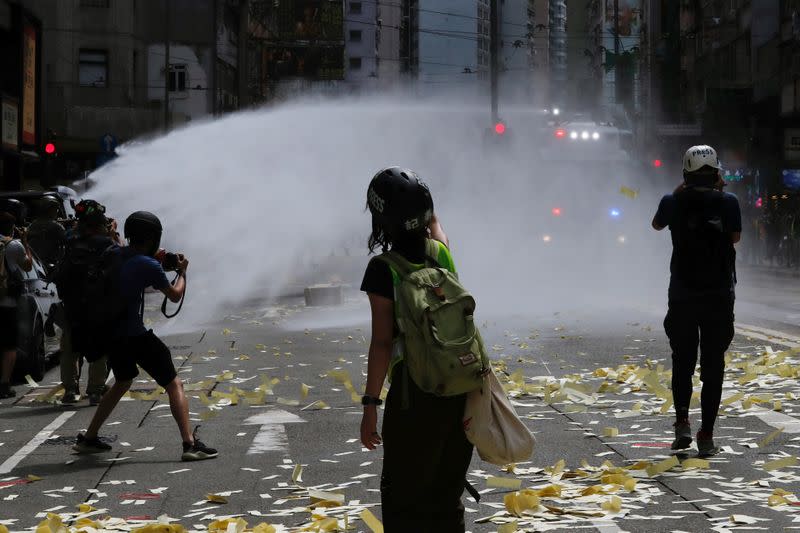 Riot police use water cannon to disperse anti-national security law protesters during a march at the anniversary of Hong Kong's handover to China from Britain in Hong Kong