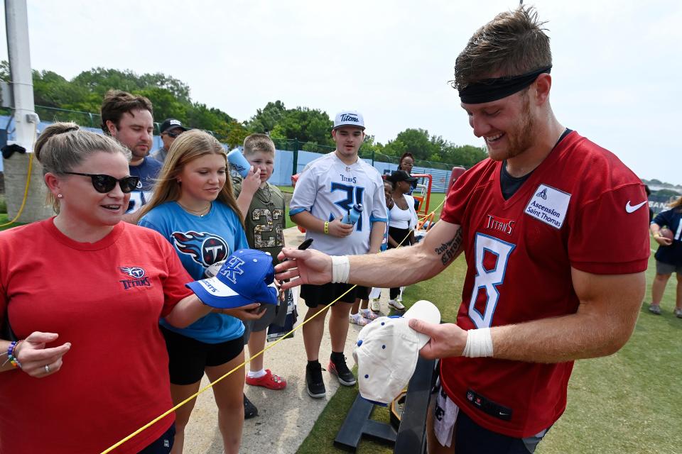 Tennessee Titans quarterback Will Levis (8) signs autographs for fans after an NFL football training camp practice Saturday, July 29, 2023, in Nashville, Tenn. (AP Photo/Mark Zaleski)