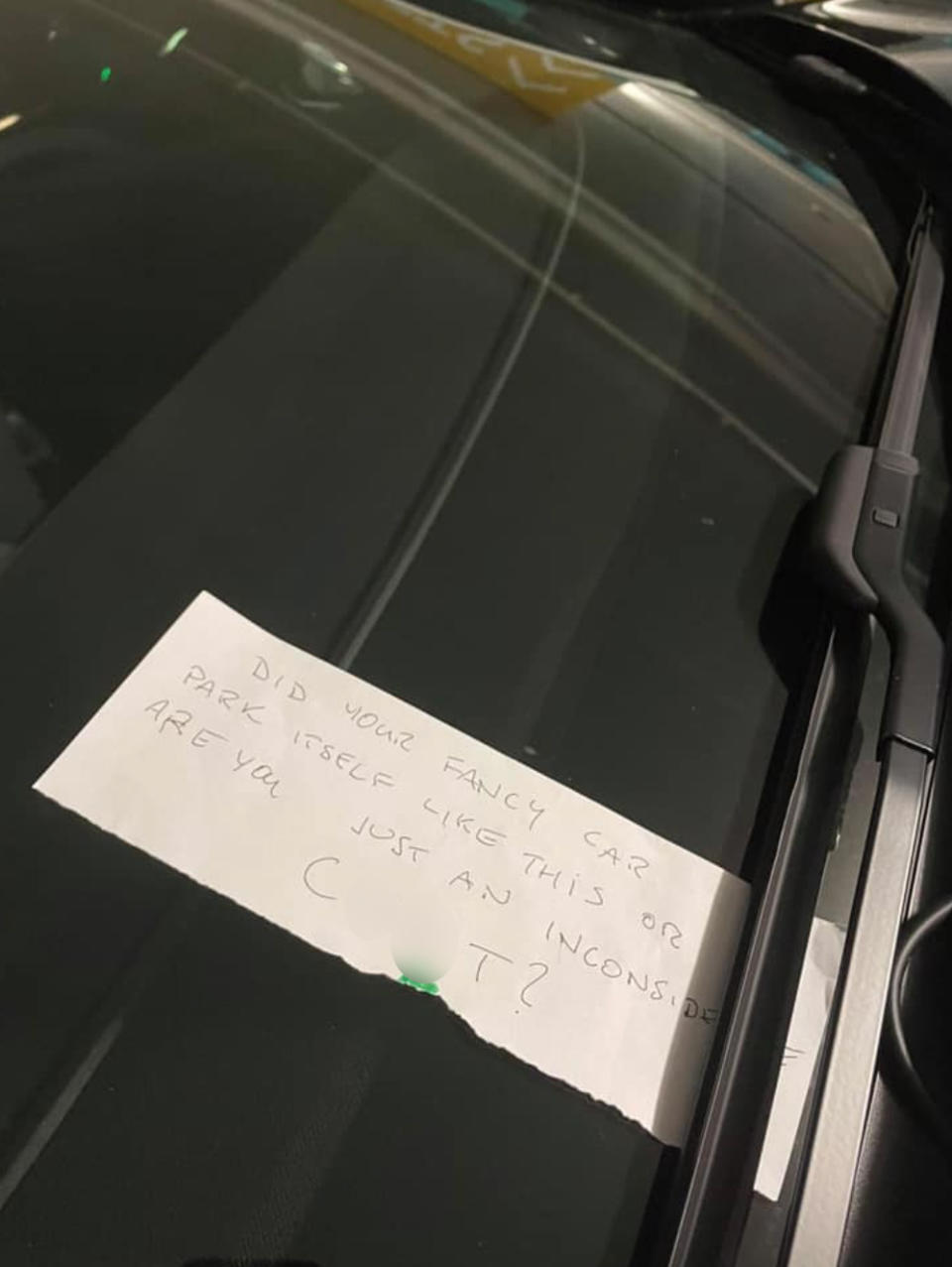 An unimpressed passerby left this nasty note for the driver of the Tesla. Source: Facebook