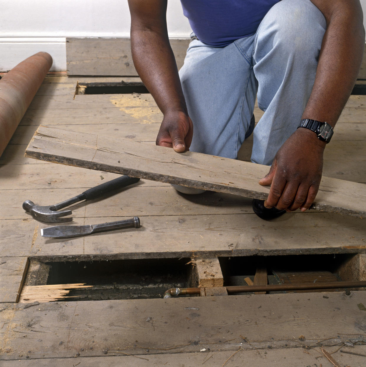 Replacing a damaged floor board. (Photo by DIY Photolibrary/Construction Photography/Avalon/Getty Images)