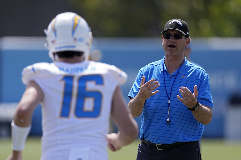 Los Angeles Chargers head coach Jim Harbaugh, right, talks with quarterback Casey Bauman during an NFL rookie minicamp football practice Friday, May 10, 2024, in Costa Mesa, Calif. (AP Photo/Mark J. Terrill)