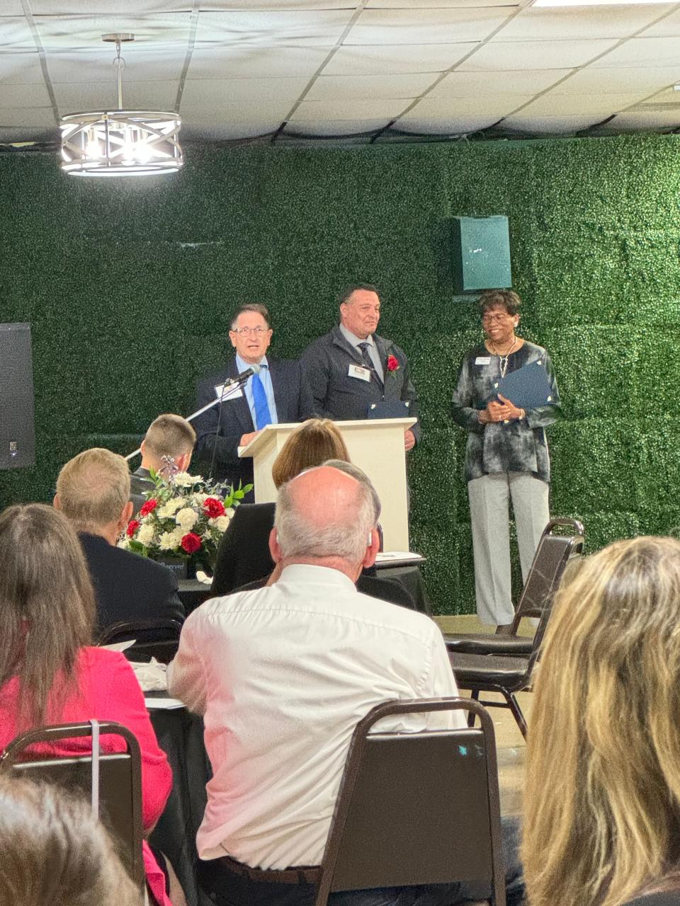 Edward Hastings, center, receives one of the Mary Brady Foundation scholarships that went to law students. Speaking is lawyer Joseph Albrechta, left, with Ohio Supreme Court Justice Melody Stewart on the right.