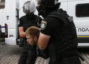 Riot police officers detain an anti-LGBT protester during the Equality March, organized by activists of the LGBT community, in Kiev, Ukraine June 17, 2018. REUTERS/Valentyn Ogirenko