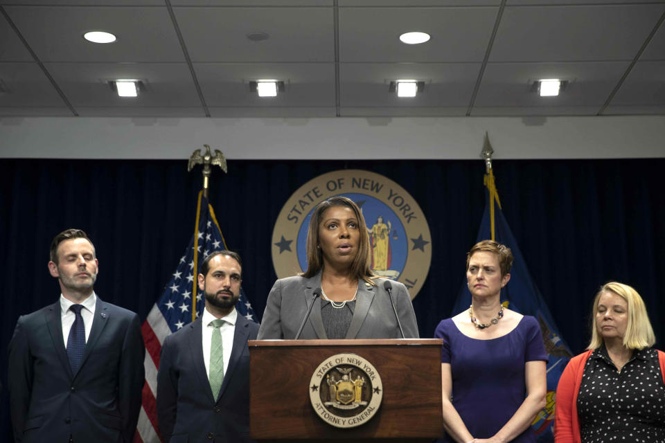 New York Attorney General Letitia James, center, speaks during a news conference, Tuesday, June 11, 2019, in New York. A group of state attorneys general led by New York and California filed a federal lawsuit Tuesday to block T-Mobile's $26.5 billion bid for Sprint, citing consumer harm. (AP Photo/Mary Altaffer)