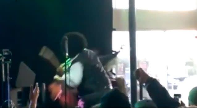 Afroman punches a woman who climbed on stage in the face, knocking her to the ground. Facebook