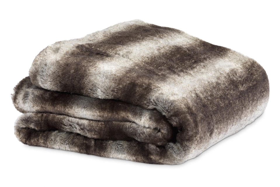 This image provided by HomeGoods shows a faux fur blanket. Marcy Blum, a NY-based wedding and event planner and HomeGoods style expert, suggests filling a basket with throws and pillows for guests who will be gathering outdoors during your Noon Year's Eve bash. (HomeGoods via AP)