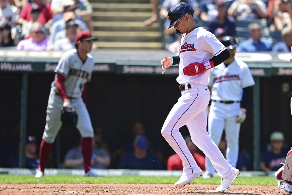 Cleveland Guardians' Andres Gimenez scores a run on a sacrifice fly hit by Myles Straw during the second inning of a baseball game against the Arizona Diamondbacks, Wednesday Aug. 3, 2022, in Cleveland. (AP Photo/David Dermer)