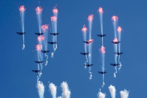 Aeroplanes forming the number 70 fly in formation - Credit: AP Photo/Ng Han Guan