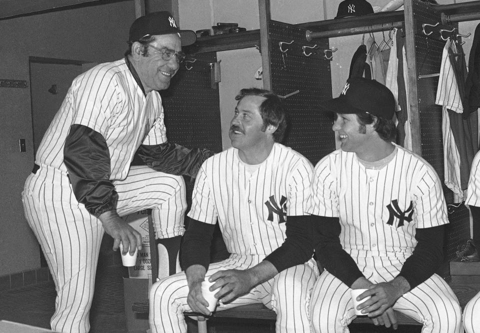 FILE - New York Yankees have a coffee break in the dressing room in Fort Lauderdale, Fla., in February 1977, before going out to work out the first day of baseball spring training. From left are coach Yogi Berra, Jim "Catfish" Hunter and Don Gullet. Gullett, a former major league pitcher and coach who played for four consecutive World Series champions in the 1970s, died Wednesday, Feb. 14, 2024. He was 73. The Cincinnati Reds, the Yankees and Baseball Hall of Fame all paid tribute to Gullett in social media posts. There was no information provided on his death, but the Cincinnati Enquirer reported he had recent health issues. (AP Photo/Bob Hannah, File)