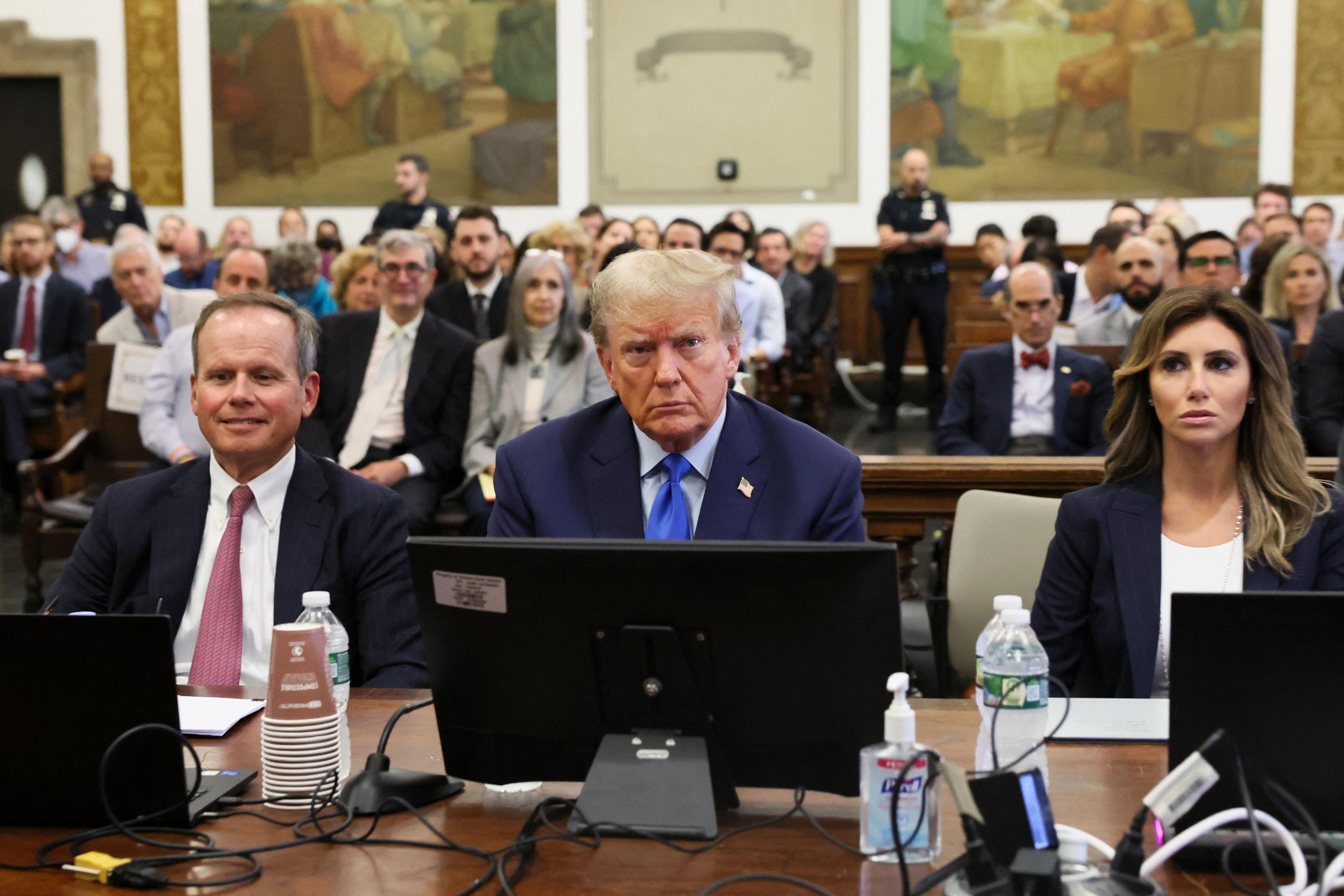 Former President Donald Trump, center, sits with his attorneys inside a courtroom during the civil fraud case brought by state Attorney General Letitia James in New York City in October 2023. 