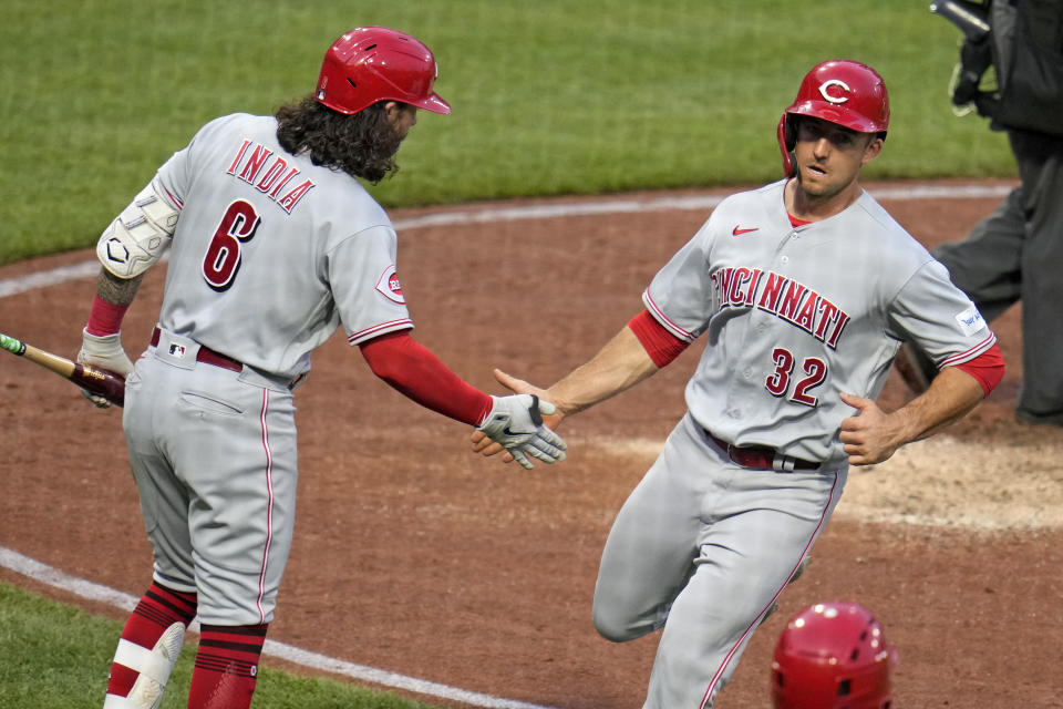 Cincinnati Reds' Jason Vosler (32) is greeted by Jonathan India after scoring on a sacrifice fly by Jose Barrero off Pittsburgh Pirates starting pitcher Mitch Keller during the fifth inning of a baseball game in Pittsburgh, Friday, April 21, 2023. (AP Photo/Gene J. Puskar)