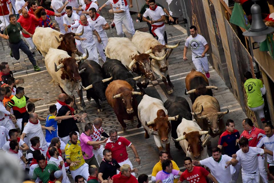 Revellers run next to fighting bulls during the running of the bulls at the San Fermin Festival, in Pamplona, northern Spain, Friday, July 12, 2019. (Photo: Alvaro Barrientos/AP)