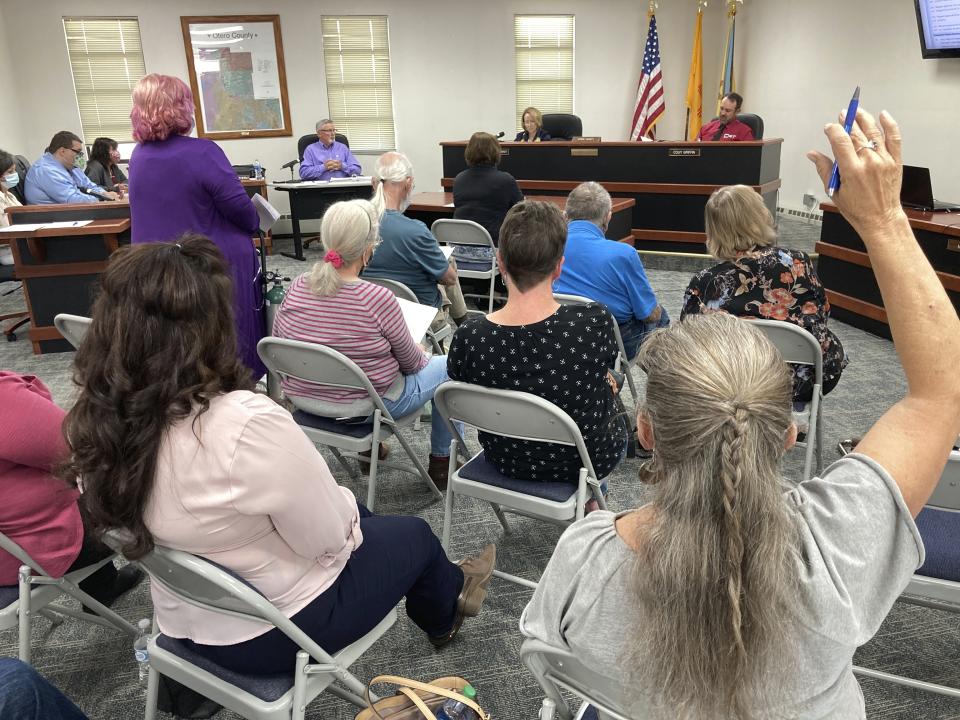 Otero County Commissioner Couy Griffin, top right, presides over a public meeting in Alamogordo, N.M., on Thursday, May 13, 2021, in a shirt with a C4T logo that stands for Cowboys for Trump. Griffin founded the support group that pays tribute to President Trump in horseback parades across the country. Griffin is reviled and revered in politically conservative Otero County as he confronts criminal charges for joining protests on the outside of the U.S. Capitol on Jan. 6. Griffin is fighting for his political future amid a recall initiative and state probes into his finances. (AP Photo/Morgan Lee)