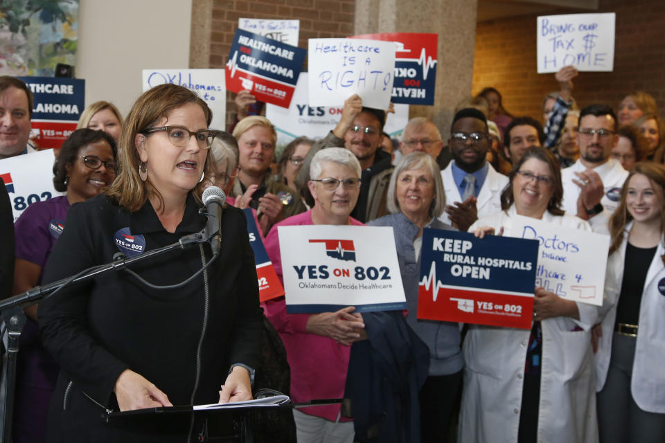 FILE - In this Thursday, Oct. 24, 2019, file photo, Amber England, who headed the campaign to put Medicaid expansion on the ballot in Oklahoma, speaks before supporters of "Yes on 802 Oklahomans Decide Healthcare," deliver petitions to the Oklahoma Secretary of State's office, in Oklahoma City. The much-anticipated Medicaid expansion is coming to Oklahoma in 2021 after years of resistance from Republicans in the Legislature and governor's office. (AP Photo/Sue Ogrocki, File)